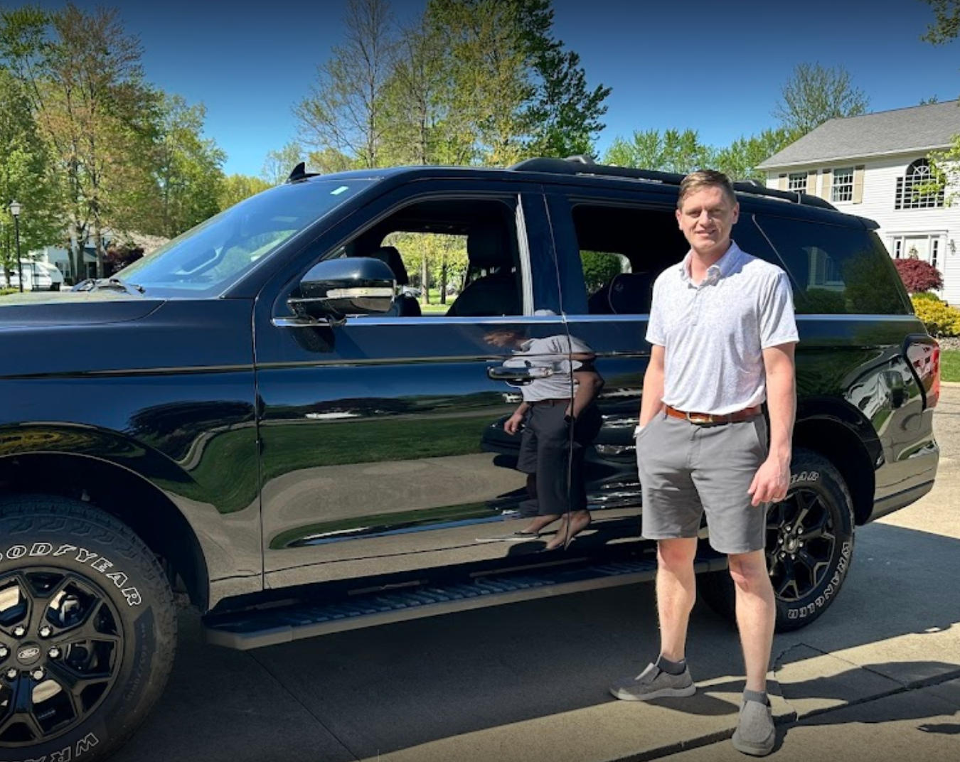 man standing next to suv